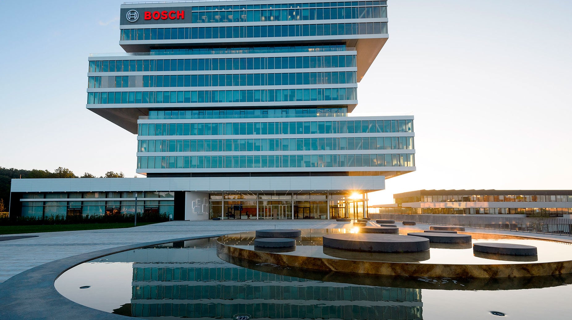 Bosch Forschungs- und Entwicklungszentrum mit modernem Glasfassaden-Hochhaus und Wasserspiegelanlage im Vordergrund